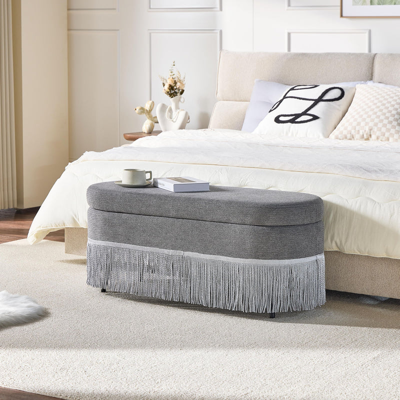 Oval Upholstered Storage Ottoman With Fringe Trim & Lift Top Lid